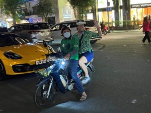 Susan on back of motorbike in Saigon